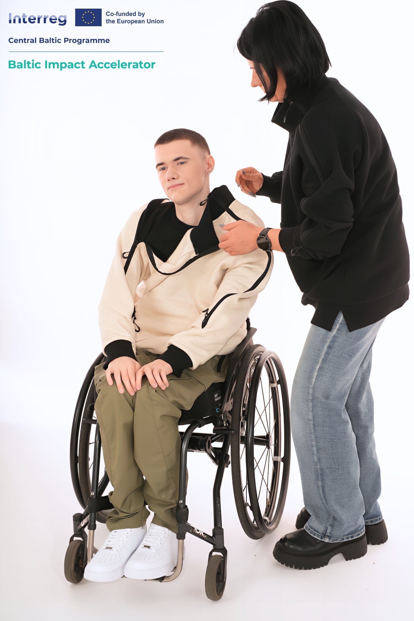 A woman is assisting a young man in a wheelchair to get dressed