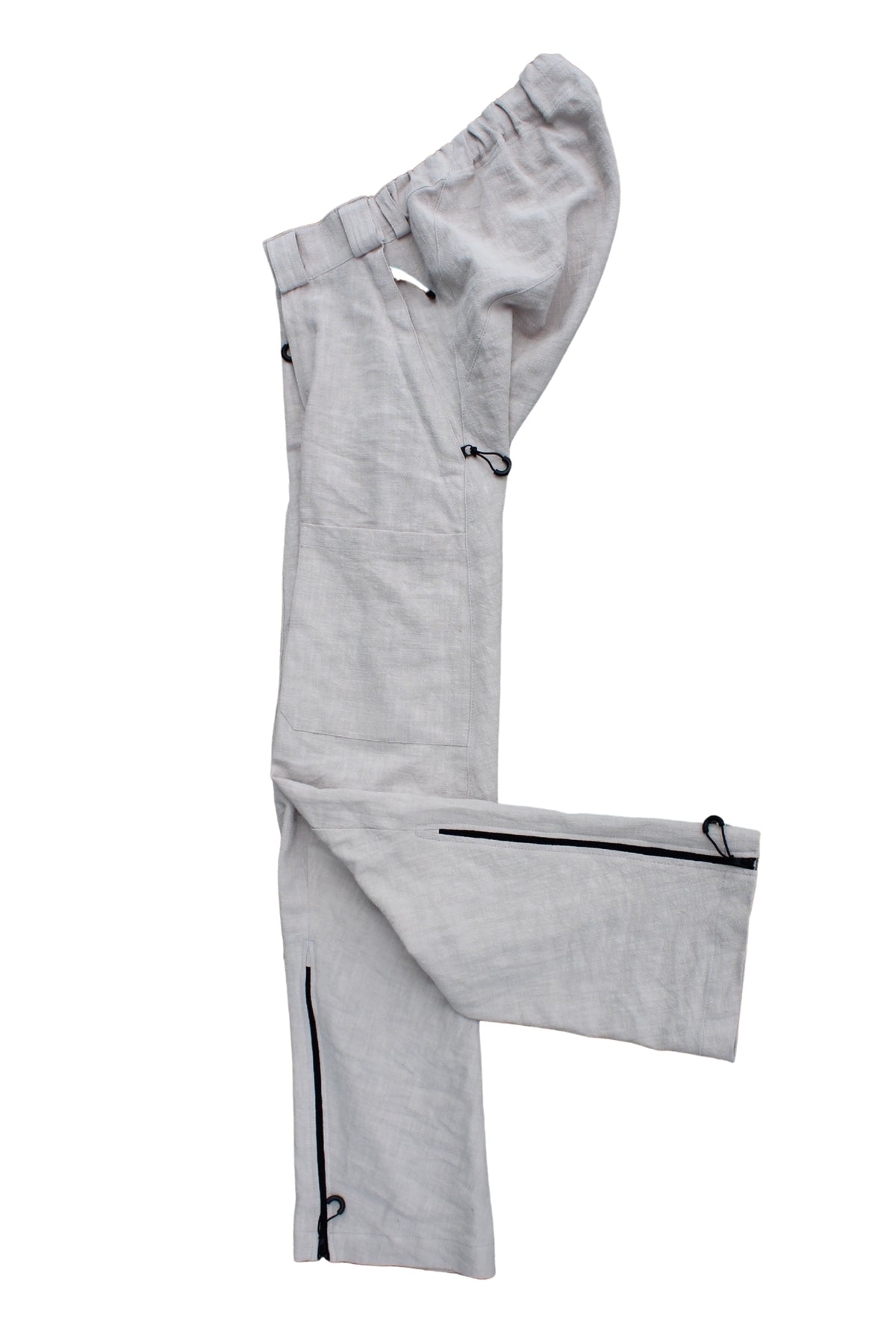 Side view of Vilber's adaptive trousers laid flat, showing the balanced side line and  zip at the inner leg.