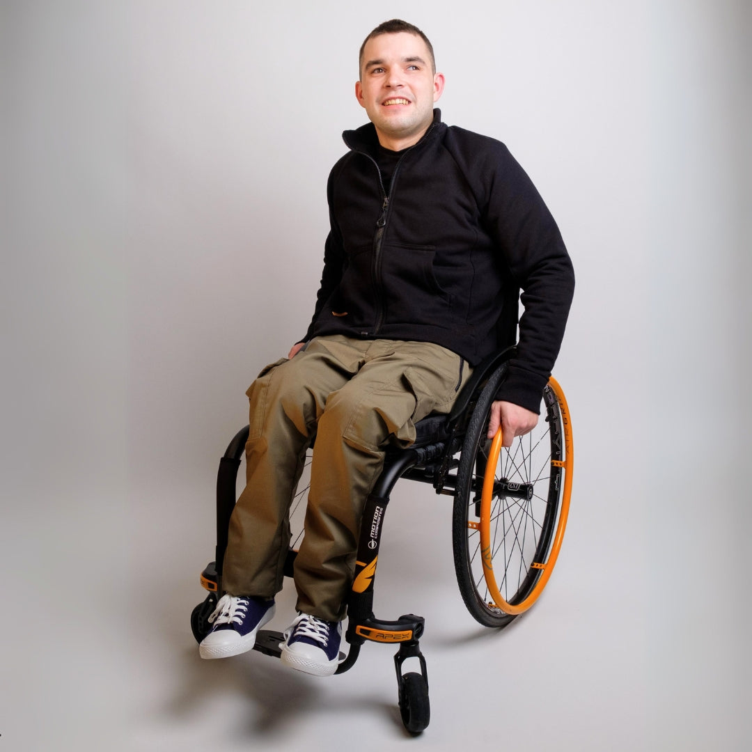 A man in wheelchair wearing adaptive clothing